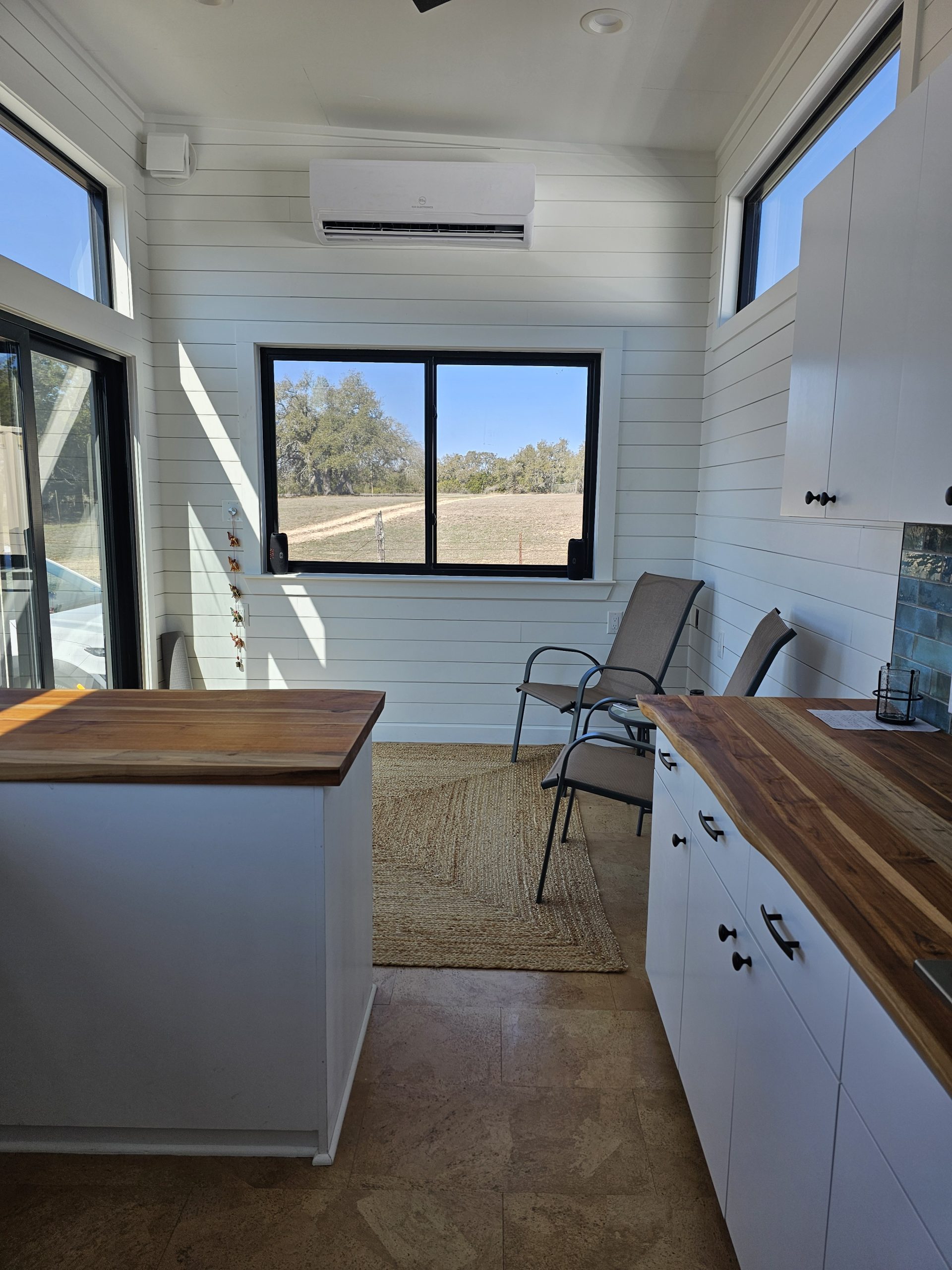 Bright tiny house living area with large windows