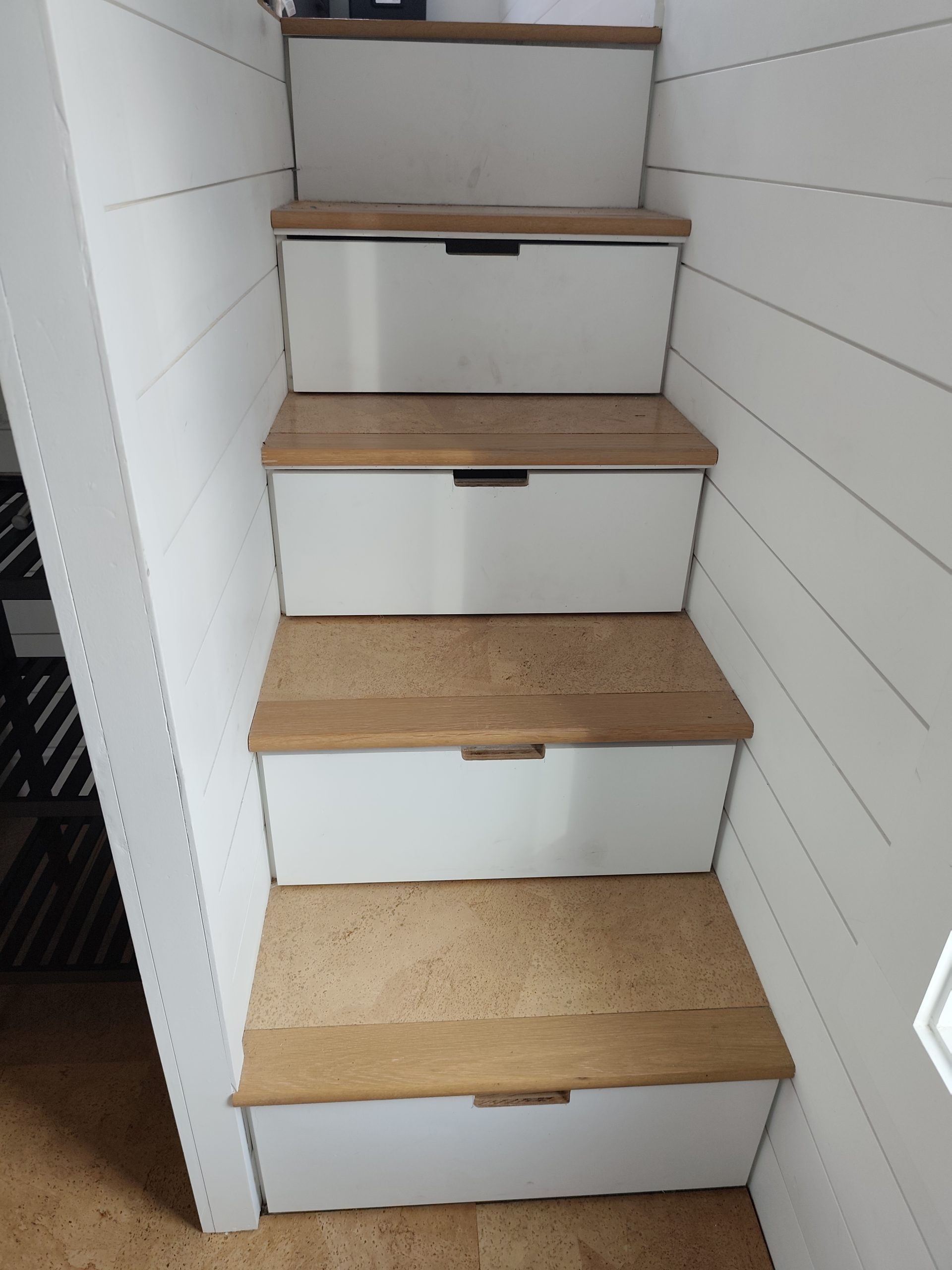 Storage stairs leading to gooseneck bedroom